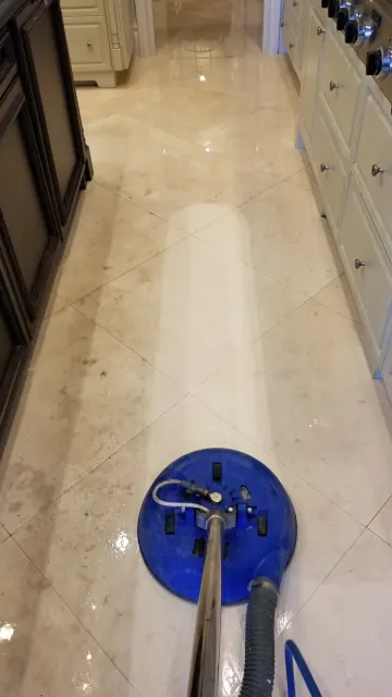 Marble floor being steam cleaned with a rotary tool