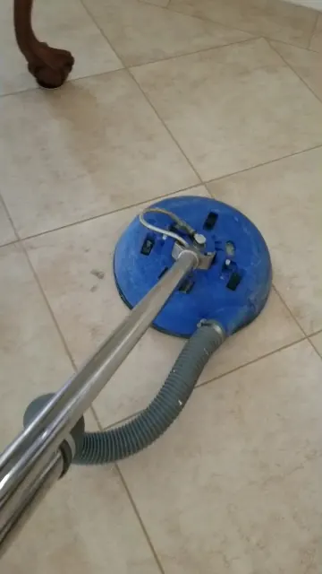Diagonal tile floor being cleaned